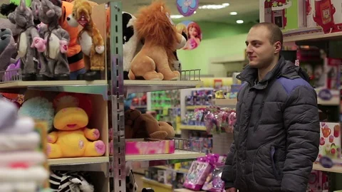 Dad chooses a soft toy in the store Video stock 71066853