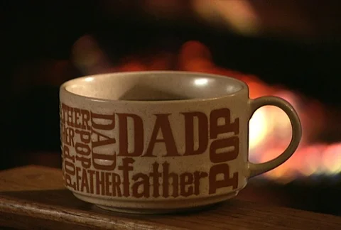 Dad coffee cup fire in background 3.2 20Mbs Stock Footage 97534346