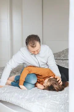 Dad comforts daughter. Problems of teenagers and support of parents. Dad sits on Stock Photos