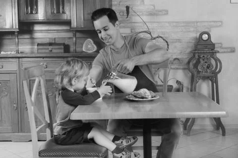 Dad cooks a breakfast Stock Photos