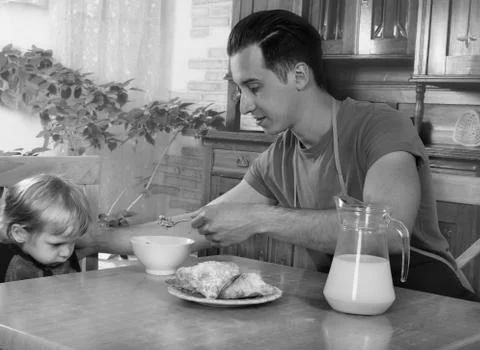 Dad cooks a breakfast Stock Photos