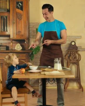 Dad cooks a breakfast Stock Photos