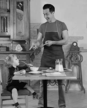 Dad cooks a breakfast Stock Photos