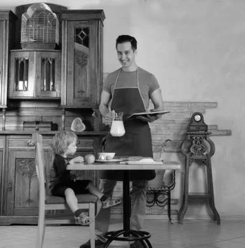 Dad cooks a breakfast Stock Photos