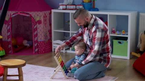Dad counts on the abacus with kid  Stock Footage 62085393