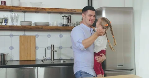 Dad dancing with daughter in kitchen Stock Footage 116336849