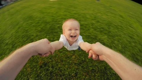 Dad hands holding spinning little happy smiling cute son playing together POV Stock Footage 106525221