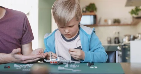 Dad helping son build model aeroplane Stock Footage 120349069