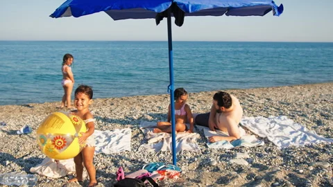 Dad With His Children Under The Beach Umbrella Stock Footage 280252358