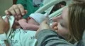 dad holds baby's hand first time and looks at her first time Video HD