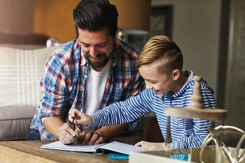 Dad, kid and help with writing in home for learning support, fine motor ski.. Stock Photos