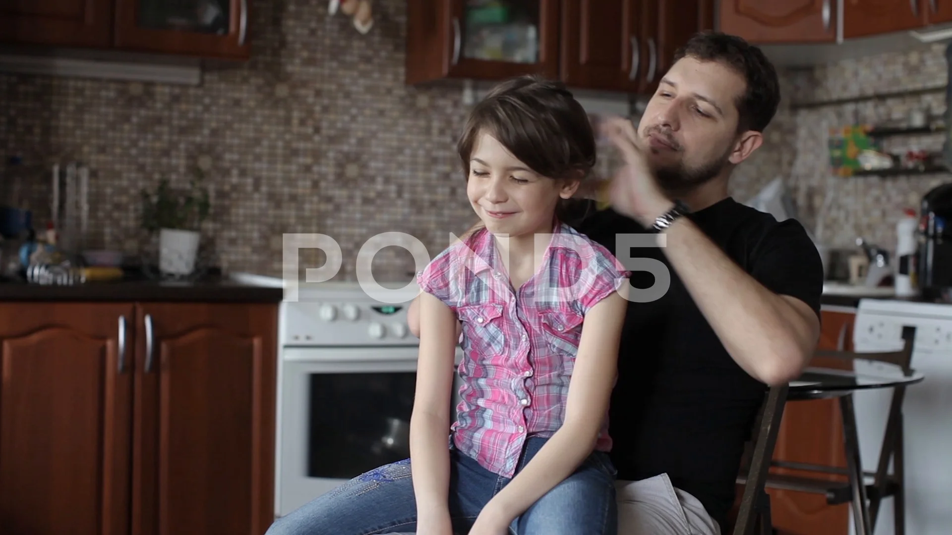 Dad Makes a Hairstyle, Pigtails to His Daughter