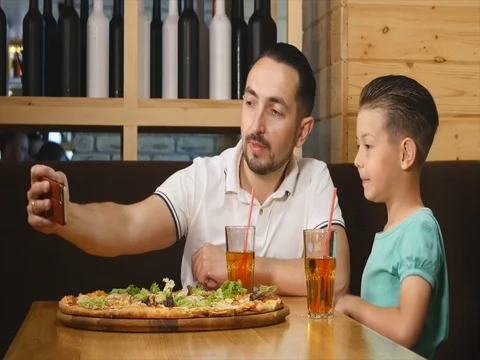 Dad makes selfie with her son in a cafe Stock Footage 76735251