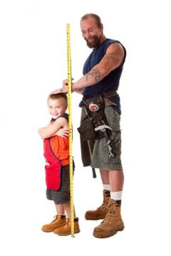 Dad measuring height of son Stock Photos