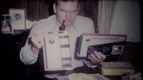 Dad opens his bithday presents at home 1950s vintage film home movie 3208 Stock Footage
