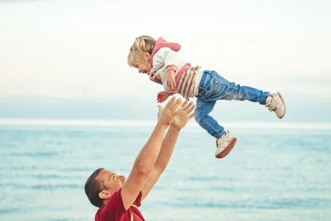Dad picks up the child Stock Photos