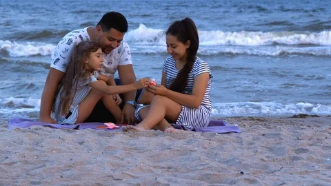 Dad playing with daughters by the sea Stock Footage 112265370
