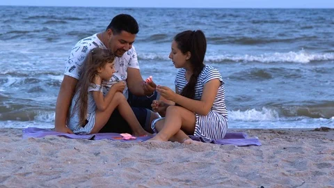 Dad playing with daughters by the sea Stock Footage 112433098