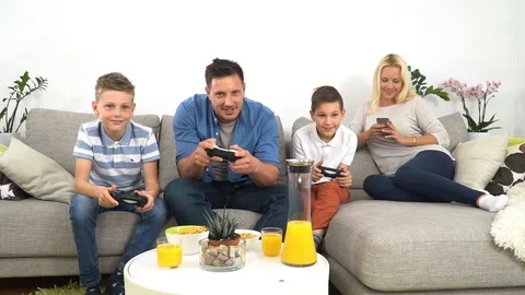 Dad playing videogames with his sons in slowmotion Stock Footage 108913245