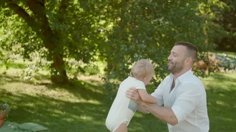 Dad plays with his son, throwing him high. Father and child spend time together Stock Footage 139756624