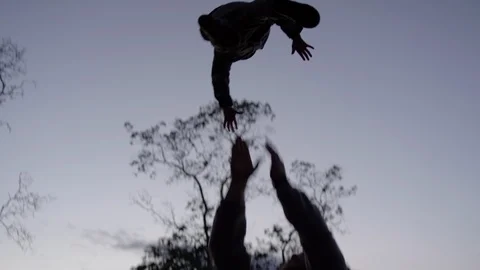 Dad Plays With Son At Sunset In Backyard, Throws Him High In Air, Slow Motion Stock Footage 96809543