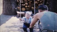 Dad Pushes His Son On Rope Swing At Country Home 1950S Family Home Movie 6007 Stock Footage