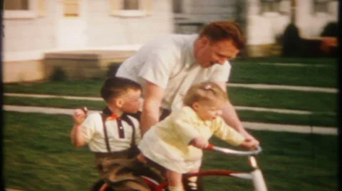 Dad pushes the kids around on the bike  1950s vintage film home movie 2145 Stock Footage