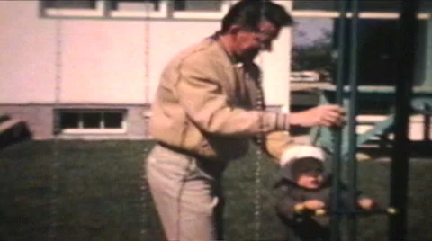 Dad Pushes Little Boy On Swing (1963 - Vintage 8mm film) Stock Footage 1056872