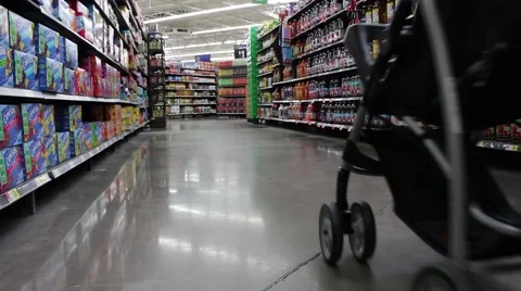 Dad pushing baby stroller down walmart aisle Vídeos de archivo 59757867