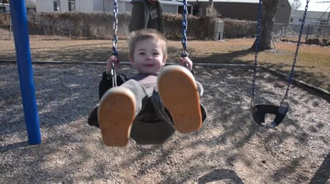 Dad pushing toddler boy on swing 8047 스톡 동영상 10745752