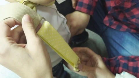 Dad Puts Son's Braces Stock Footage 73962655