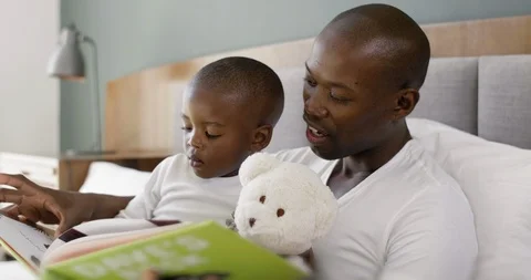 Dad reading bedtime stories to son Stock Footage 119611852