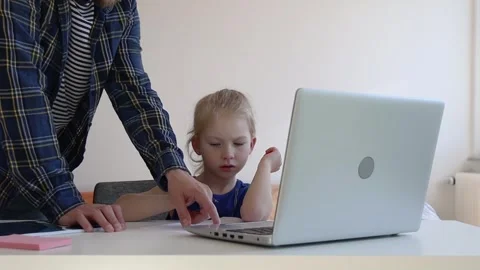 Dad shows daughter how to do a task from the Internet. Stock Footage 244007949