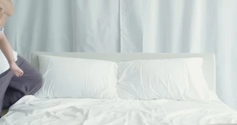 Dad sitting in bed and reading storybook to his son and daughter Stock Footage 100946955