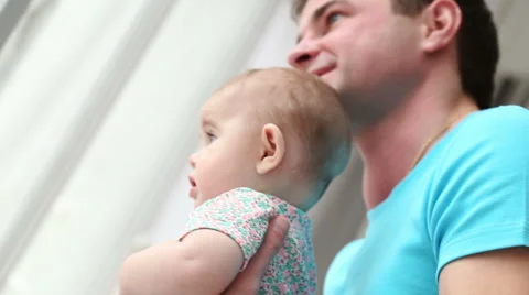 Dad with a small child looking out the window closeup - dolly shot Stock Footage 48395941