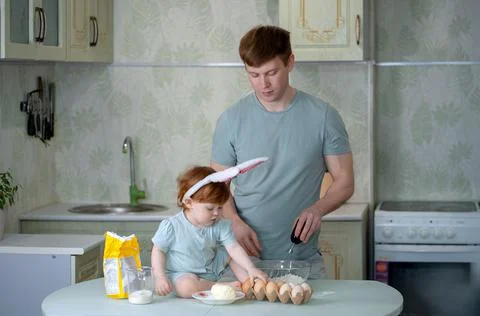 Dad with a small child is preparing an Easter cake Stock Photos