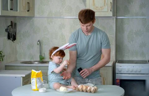 Dad with a small child is preparing an Easter cake Stock Photos