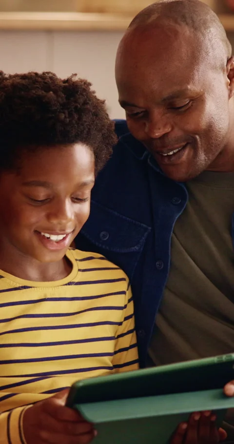 Dad, son and tablet on sofa for elearning, bonding and educational app in home Stock Footage 342851480