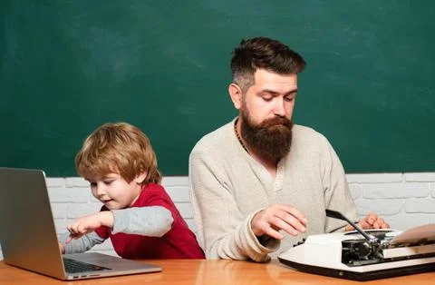 Dad son are concentrated on the problem. Daddy and son together. Concept of Stock Photos