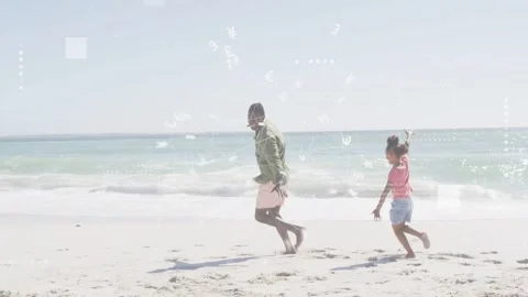 Dad starting balancing steps playing and bonding leading daughter along beach Stock Footage 333720228