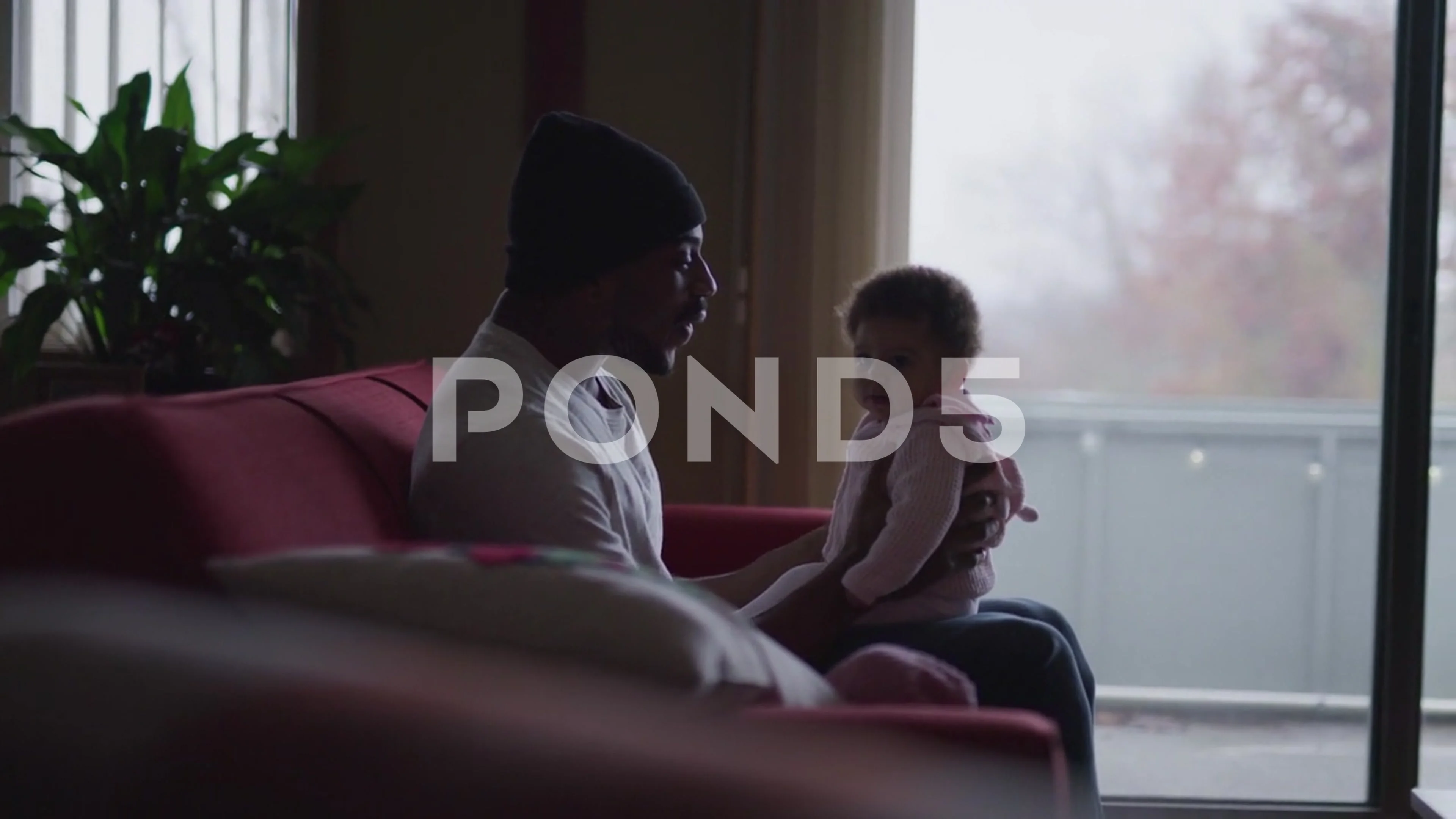 Dad Talks To Daughter Sitting On Lap