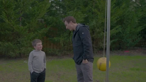 Dad Talks To Son About Tetherball Game In Yard Stock Footage 208781891