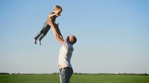 Dad throws baby son into the sky. In nature Stock Footage 61243062