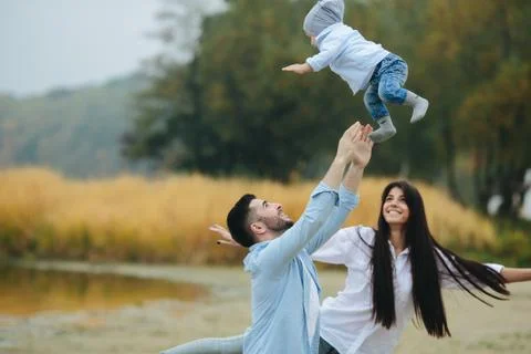 Dad throws up his young son Stock Photos