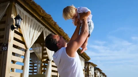 Dad tosses his son up at a beach resort Video stock 234470269
