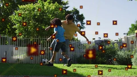 Dad touching soccer ball and dribbling across yard, boy chasing, social icons Stock Footage 333278015