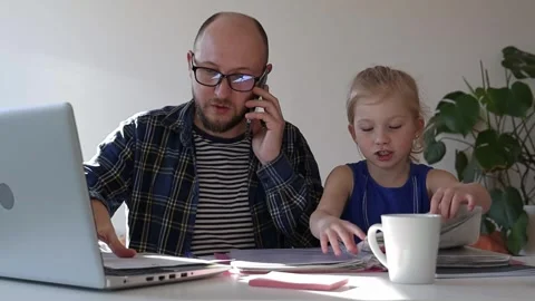 Dad tries to work at home, but his daughter distracts him. Stock-Footage 244008105