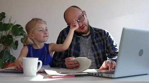 Dad tries to work at home, but his daughter distracts him. Stock Footage 244008127