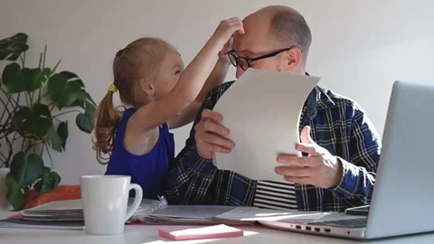 Dad trying to work and play with daughter at the same time. Stock Footage 244008138