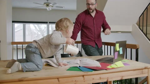 Dad trying to work with son at home- Stock Footage 145853937